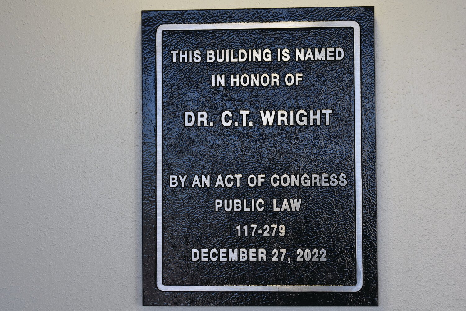 This new plaque hangs on the wall inside the Post Office entrance.