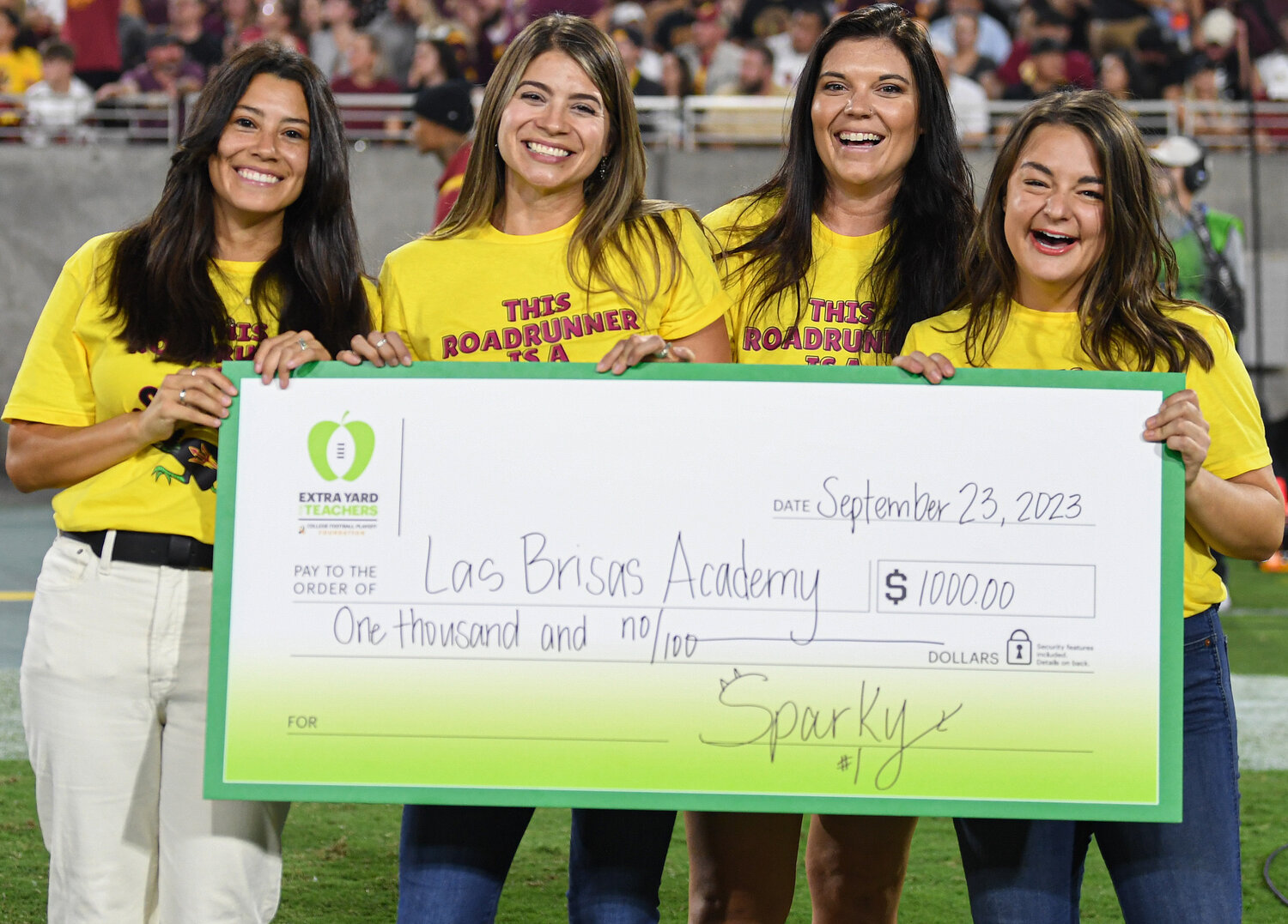 Las Brisas Academy representatives receive the $1,000 Extra Yard for Teachers Grant from Arizona State University.