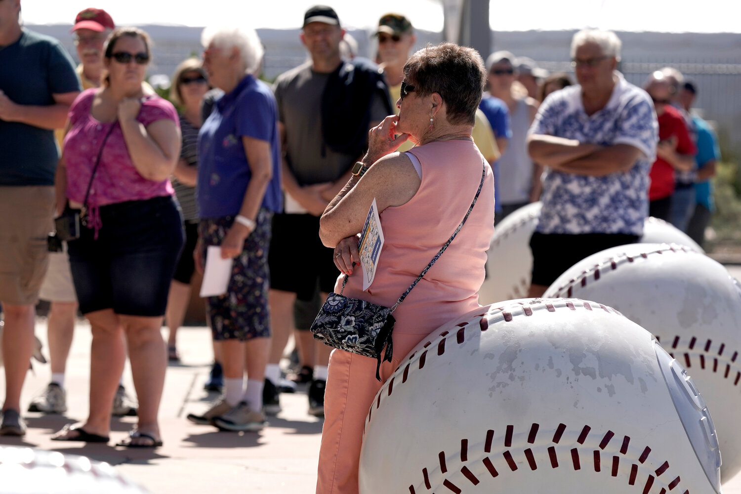 People wait in line to buy tickets for spring training games at the Peoria Sports Complex in this March 16, 2022, file photo.