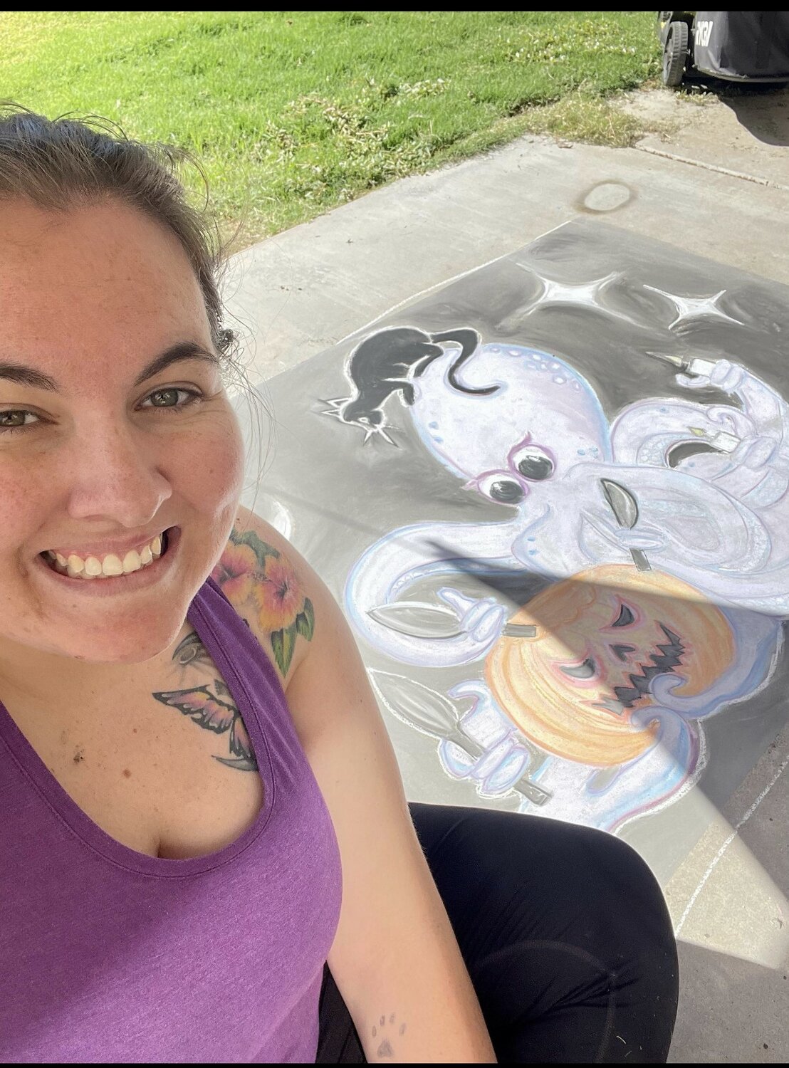 Kelcey Ruiz shows off her drawing of an octopus, which won Best In Show at the first annual Halloween Chalk Contest, presented by The Chalk of the Town.