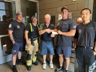 Pictured, Wisconsin Club President Greg Smith presents the 2023 picnic proceeds donation check to the Sun City Fire Department.