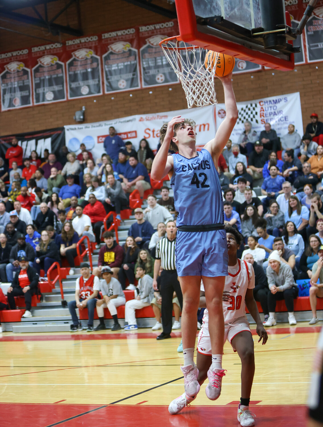 Cactus junior center Bradey Henige turns to dunk during a Feb. 8 boys basketball Open Division first round game at Ironwood High School Feb. 8. Henige is back after leading the nation at 20.6 rebounds per game.