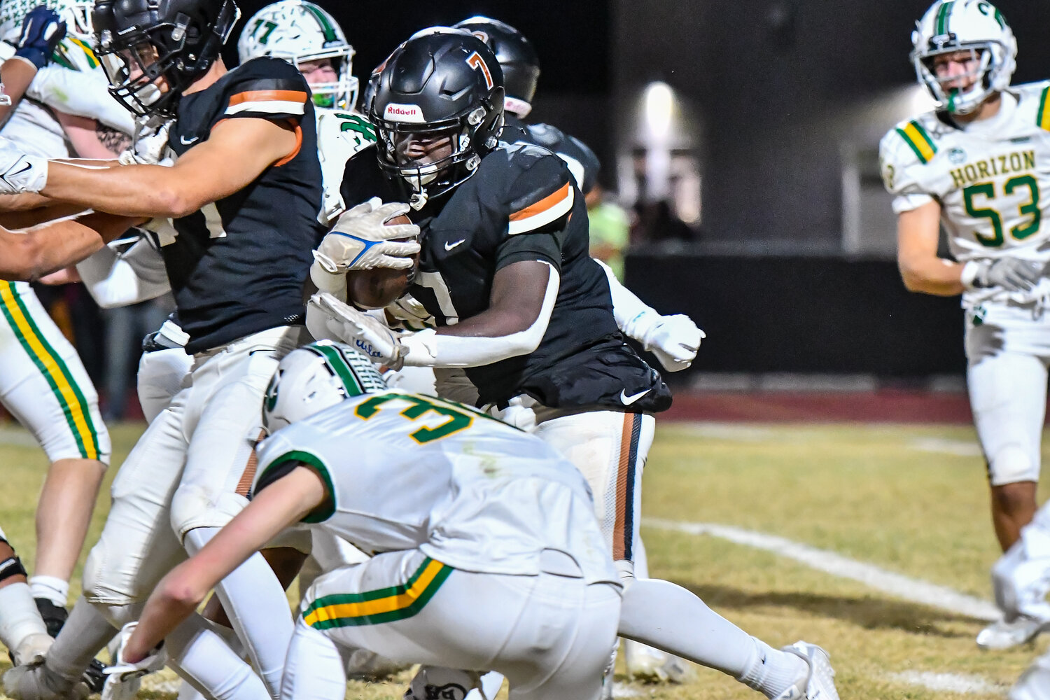Desert Edge senior running back Markhi McKinnon stiff arms a Horizon defensive player trying to tackle him low during a 5A football semifinal Nov. 24 in Goodyear.