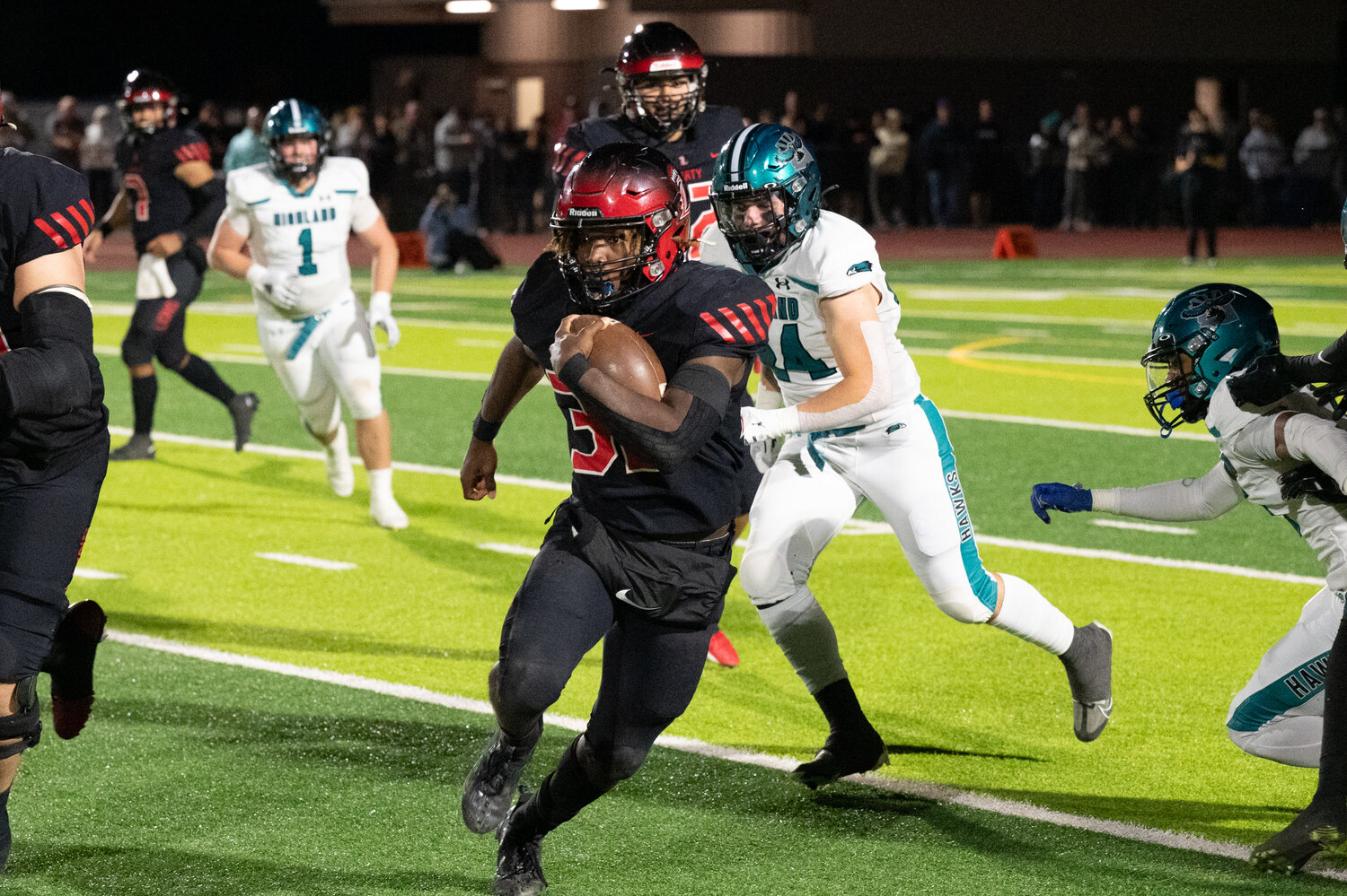 Liberty running back Jon Wilson (32) runs upfield for yardage on Saturday night against Highland. (Courtesy Picture Lady Photography for West Valley Preps)
