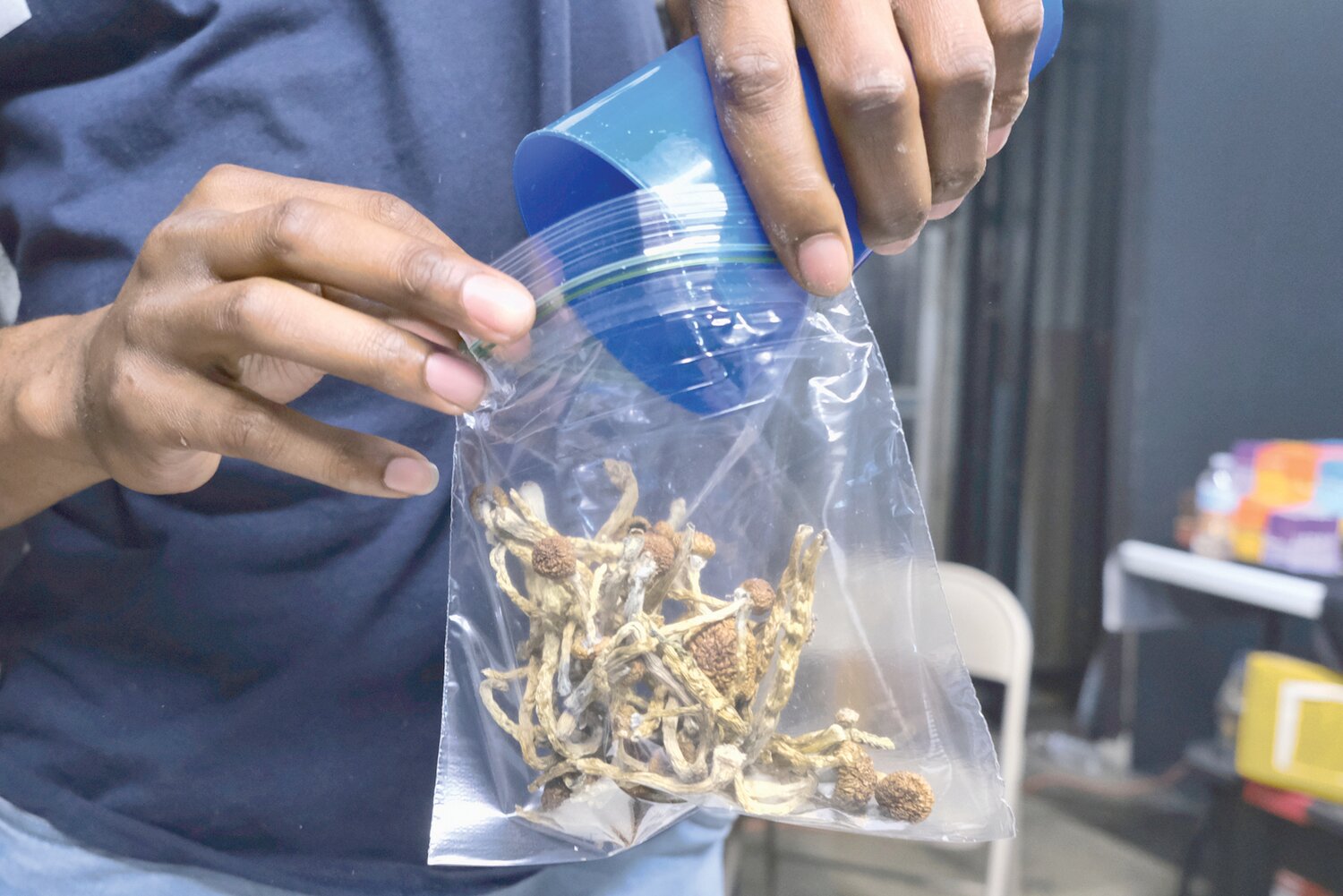 A vendor bags psilocybin mushrooms at a cannabis marketplace on May 24, 2019 in Los Angeles. Arizona is taking the first steps to what could be legalizing the use of certain mushrooms — and, specifically psiolocybin — for use, at least for some people. (The Associated Press/Richard Vogel)