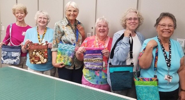 Showing off their completed bags are, from left, Sue Steele, Ginny Bignell, Walita Mroz, Eva Weisberg, Patti O’Neil and Helen Grant.