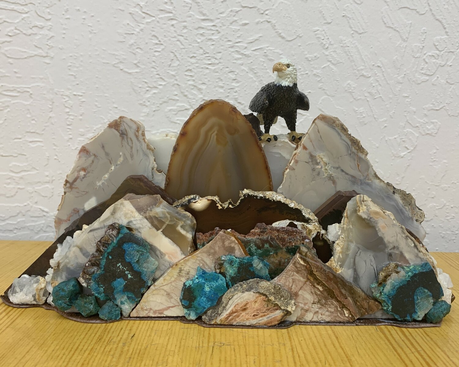 Pictured, the Lapidary Club’s window display in November showcased rock slabs and stones artistically combined to form mountain scenery.