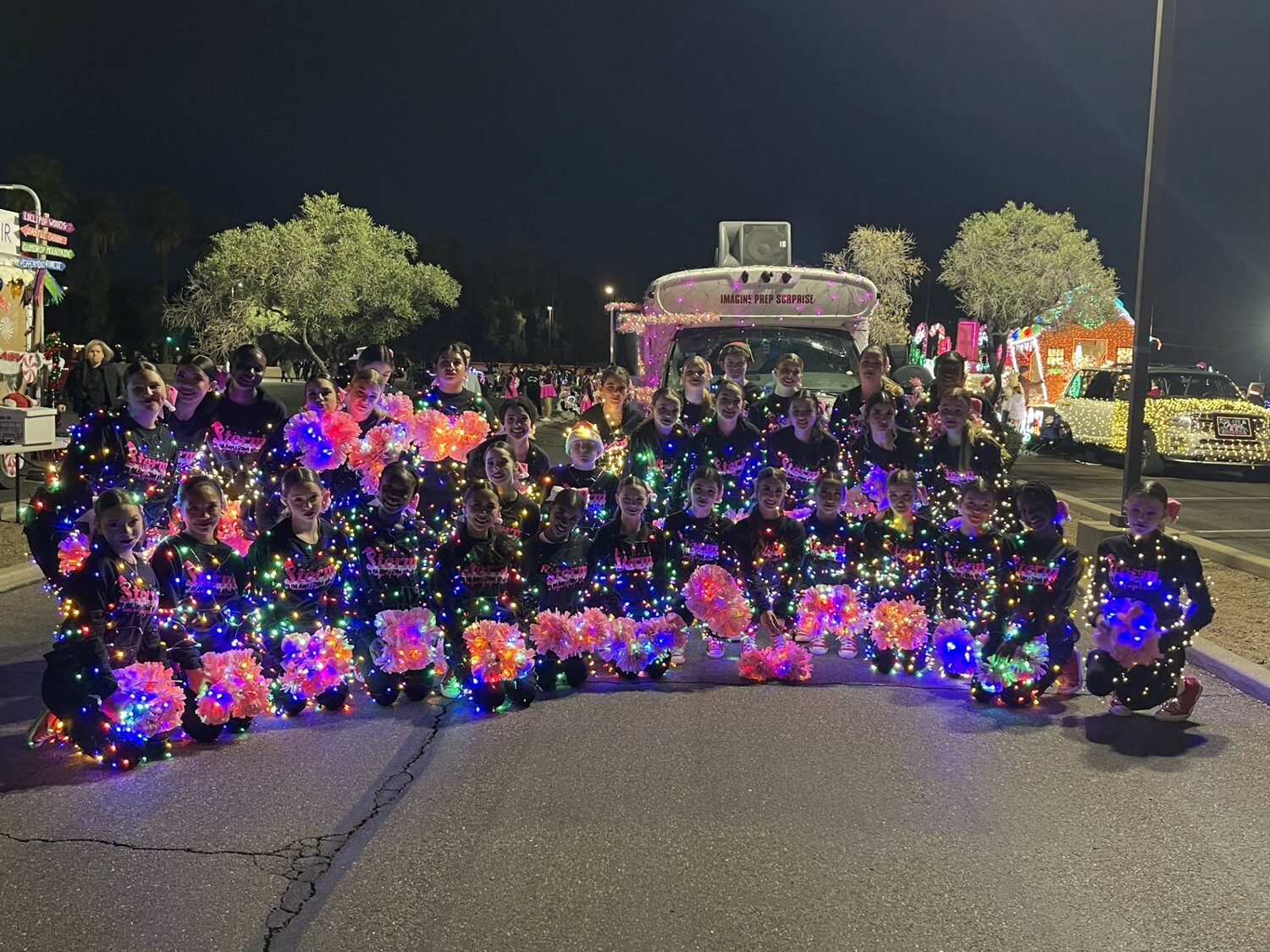 The middle and high school cheer teams at Imagine Prep walked in the APS Light Parade Dec. 2.