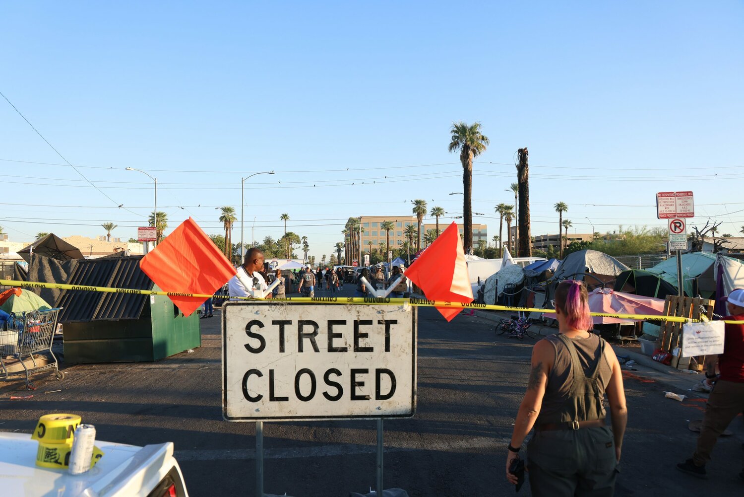 Officials from the city of Phoenix block off 12th Avenue between Jefferson and Madison streets on the morning of Oct. 20 to facilitate the clearing of a homeless encampment under a court order issued earlier this year. (Photo by John Leos/Cronkite News)
