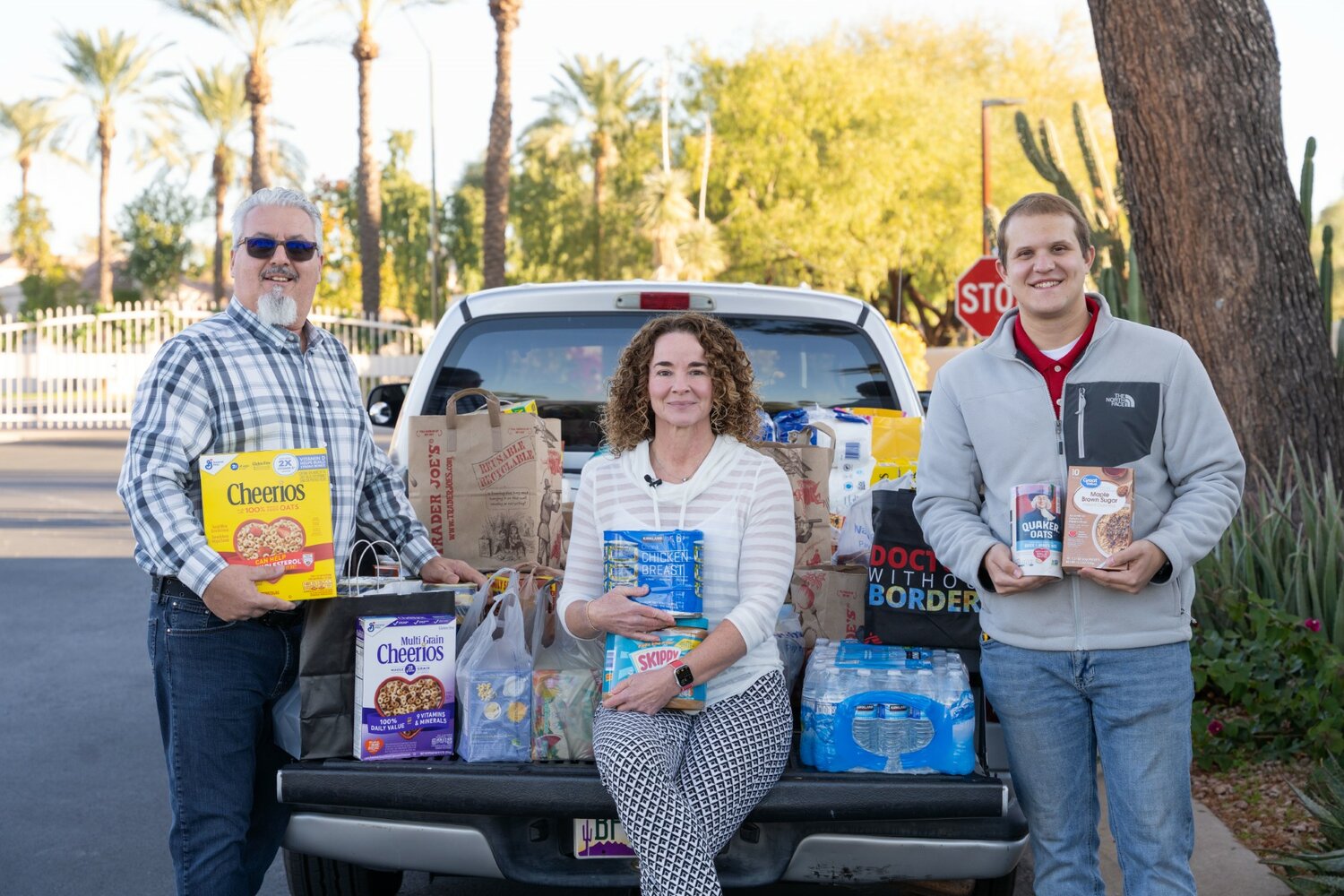 Hospice of the Valley facilities manager Joe Campaigne, left, and technician Jace Orcutt met Sandpiper community manager Maggie Martel when they picked up piles of boxes of donated food. 