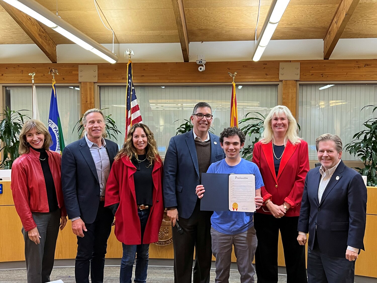 Charlie Kanarish representing The Jones-Gordon School holds the proclamation for Teen Dating Violence Awareness Month with Paradise Valley Town Council.