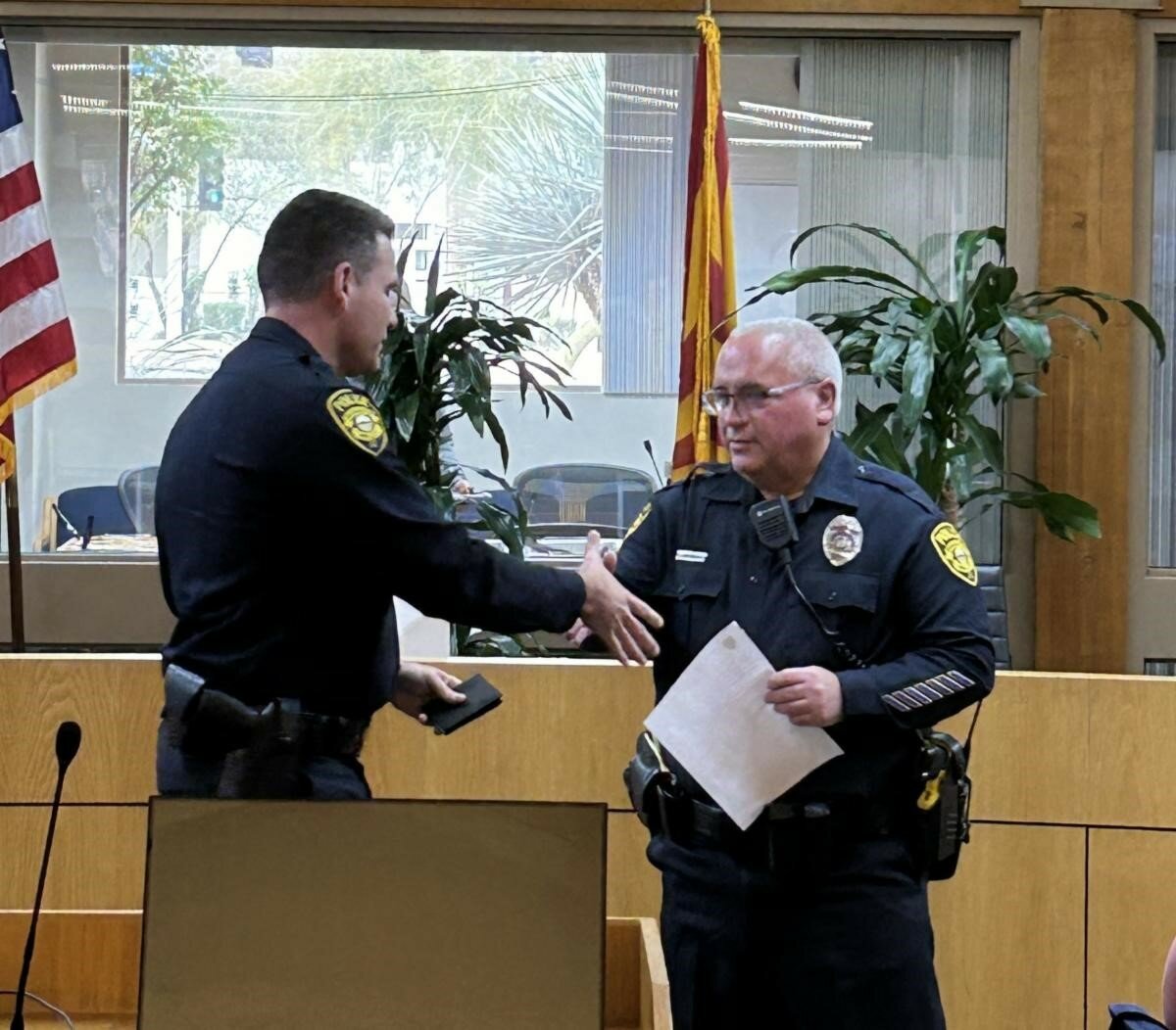 Officer James Gibson shakes hands with Chief Freeman Carney at his retirement celebration.
