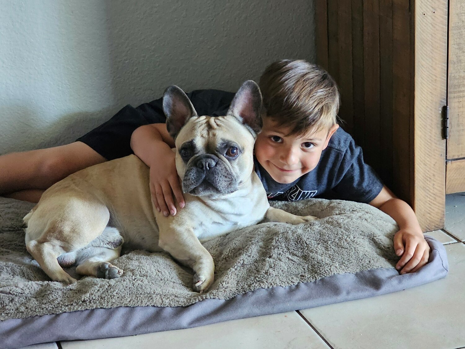 Childhood cancer survivor Anthony Paoletti, 8, enjoys spending time with his dog, Franklin.